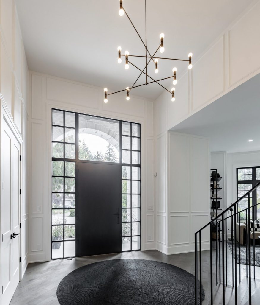 A white entryway with crisp painted trim and doors