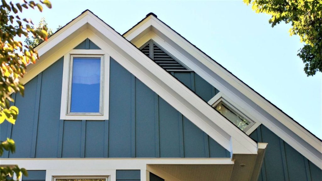 Board and batten siding repaired and painted blue