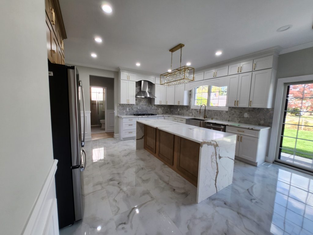 A large kitchen with an island, ready for cabinet refinishing