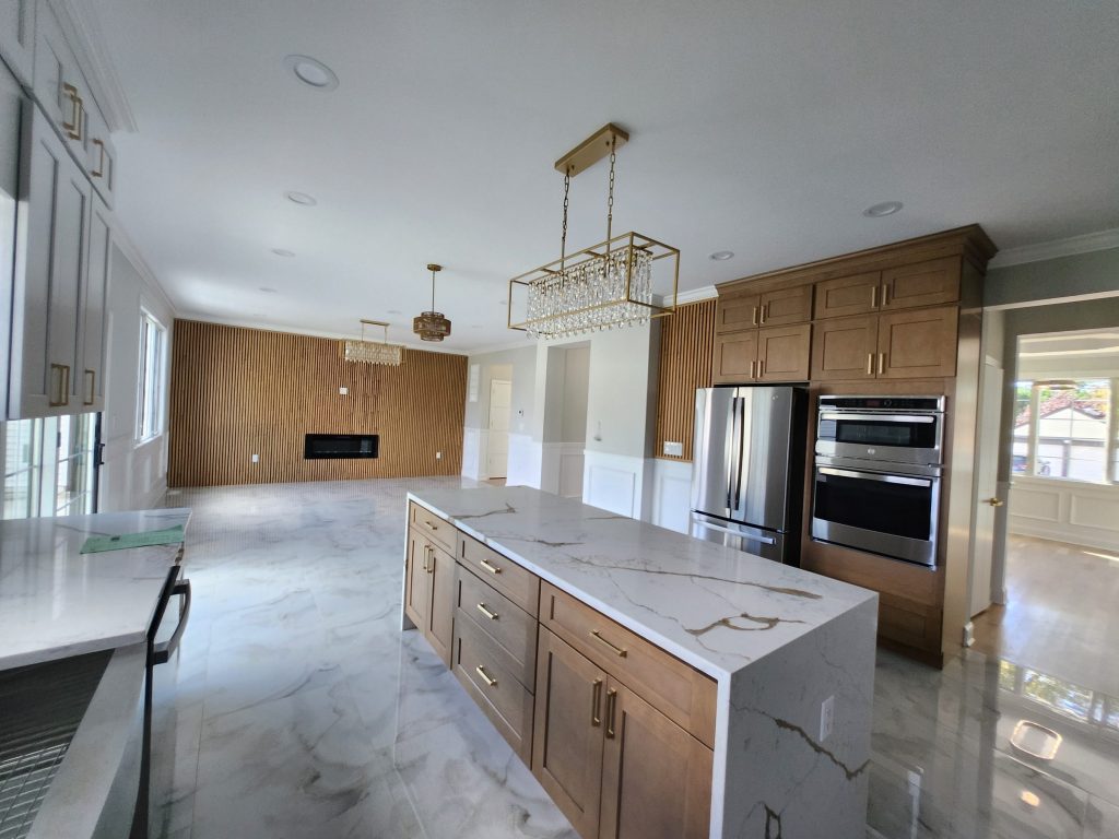 A kitchen with wood cabinetry and an island