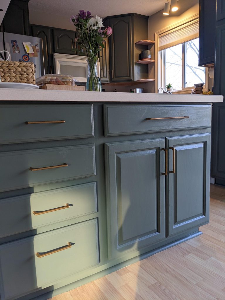 Green painted cabinets with brass pulls